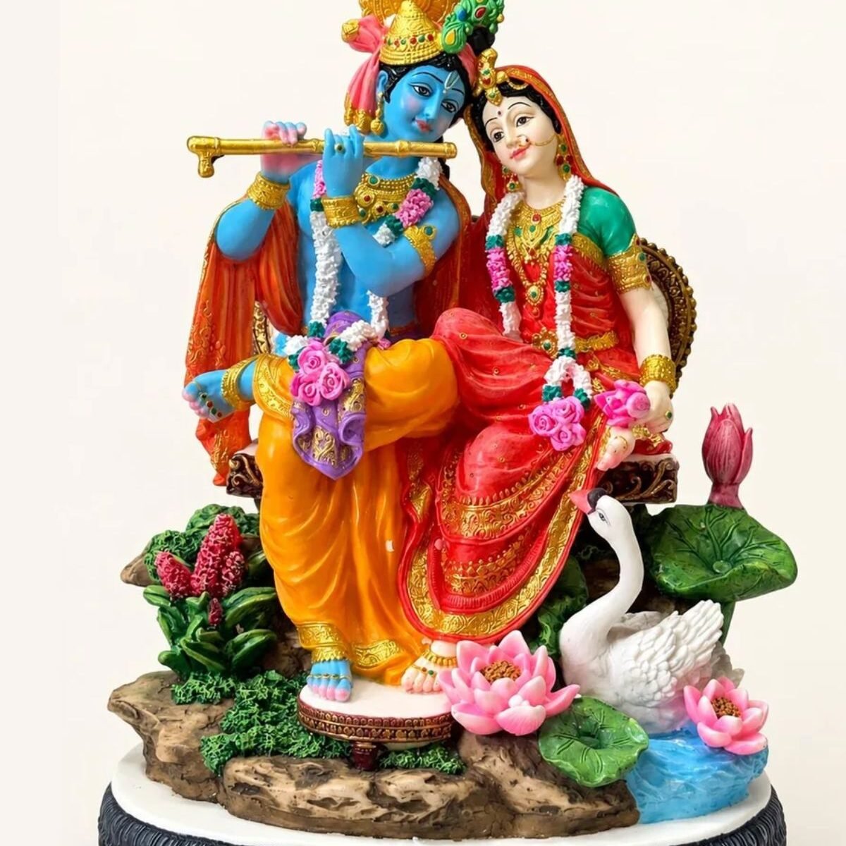 1.divine love radha krishna resin statue with swan, lotus flowers sitting in vrindavan